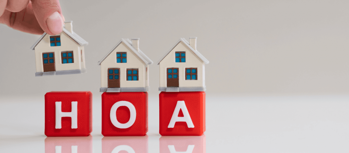 Modern HOA management concepts with miniature houses and blocks spelling HOA.