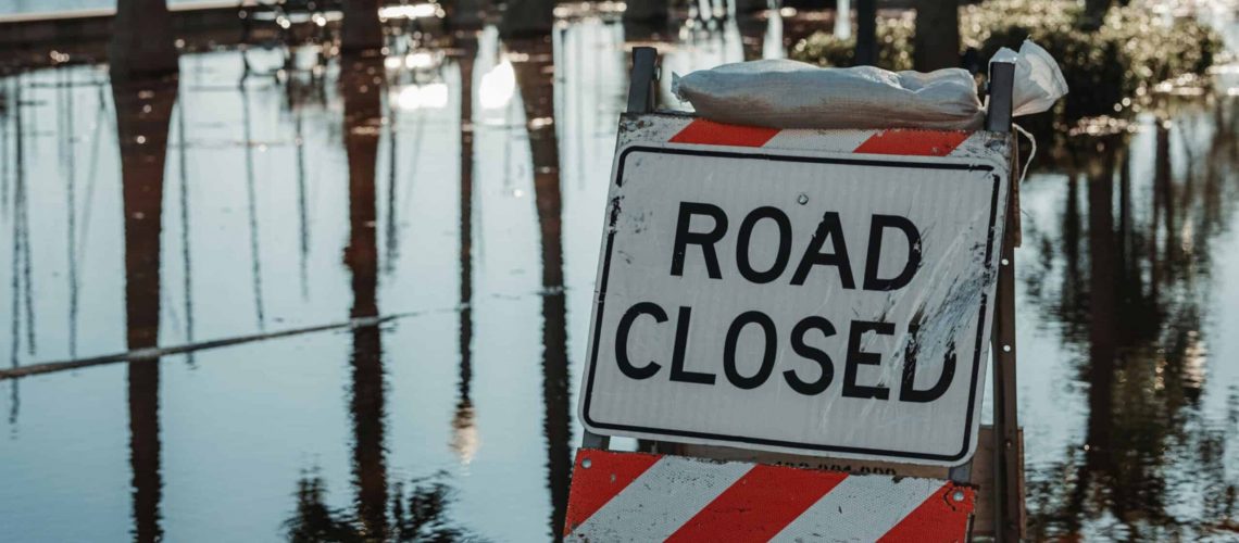 Flooded road closure sign warning of flood damage in Houston, Texas.