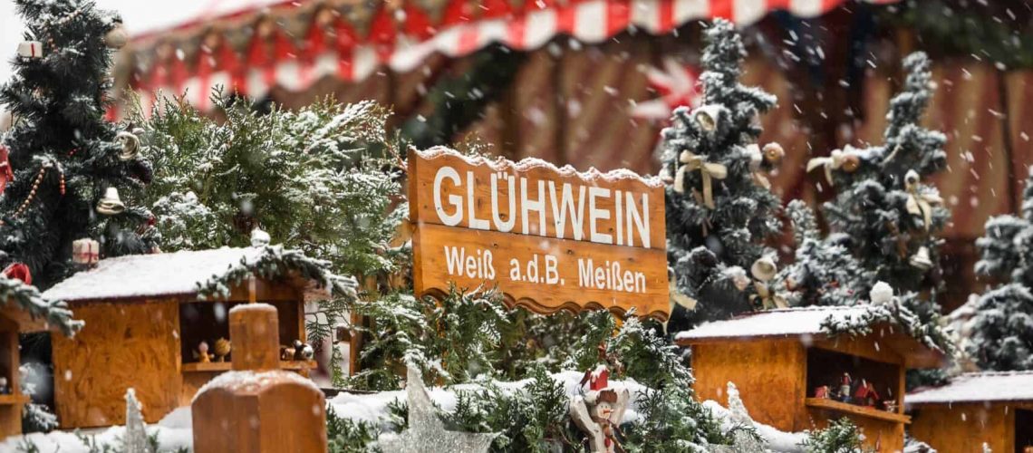 Carousel at Houston's festive Christmas market with holiday decorations and snow.
