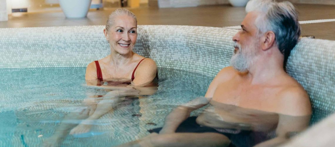 Active seniors enjoying a relaxing swim in a community pool.