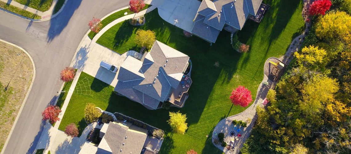 Aerial view of a residential neighborhood with HOA-managed homes and landscaped areas.