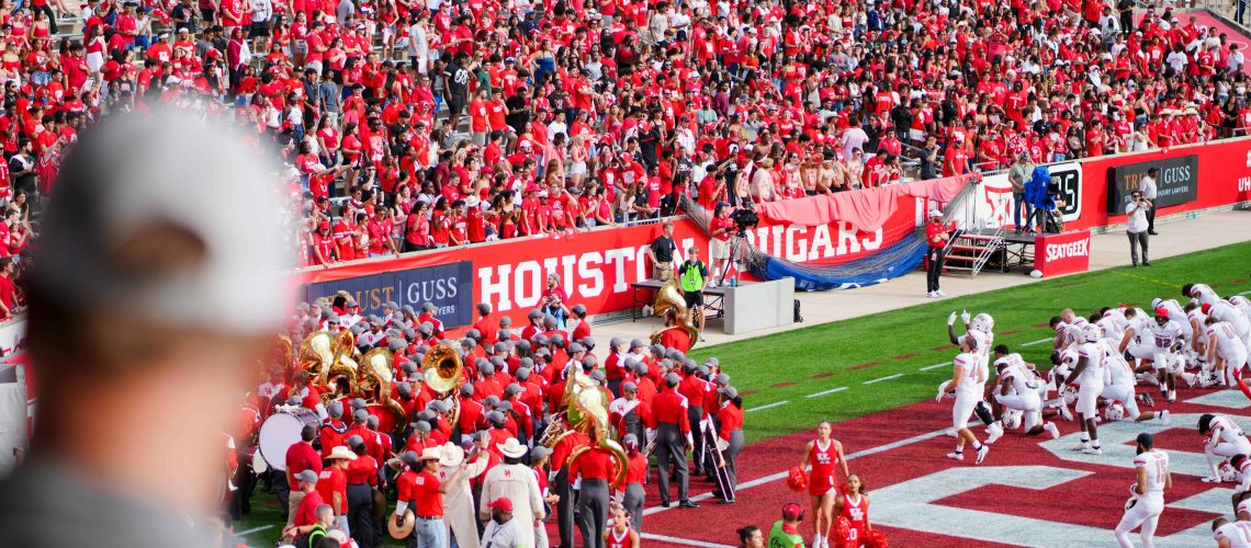 Crowded Houston football stadium with fans and players during game 2024.