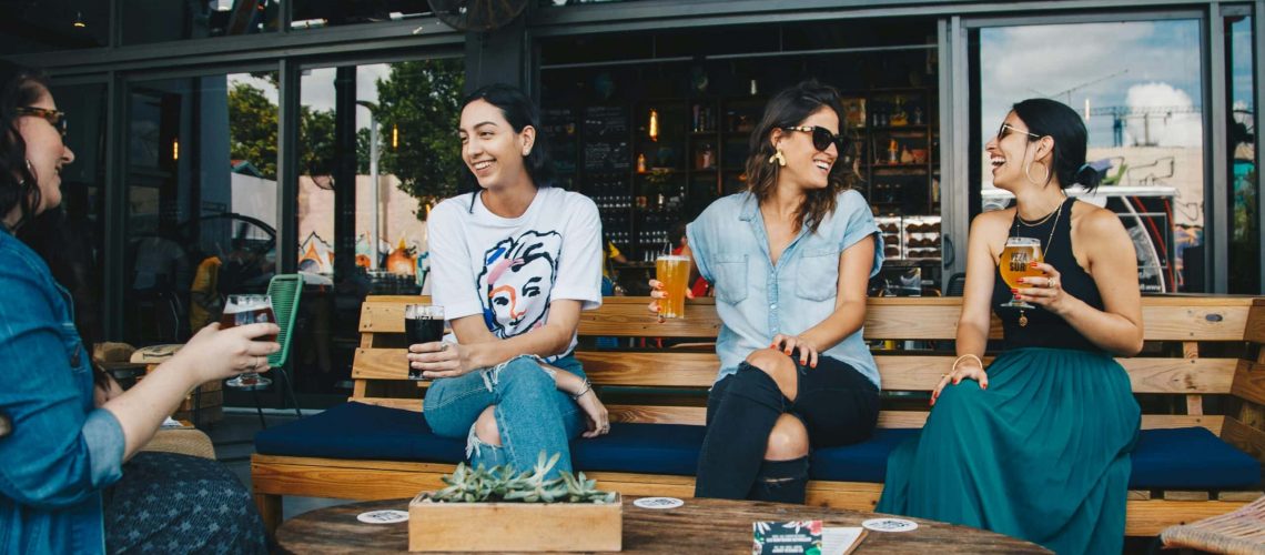 Enjoying drinks and conversation at a popular Houston outdoor restaurant patio.