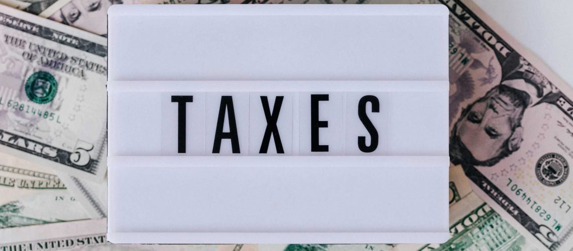 HOA and tax season preparation with money and tax documents.