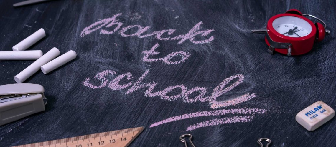 School safety tips chalkboard with "back to school" message and safety tools.