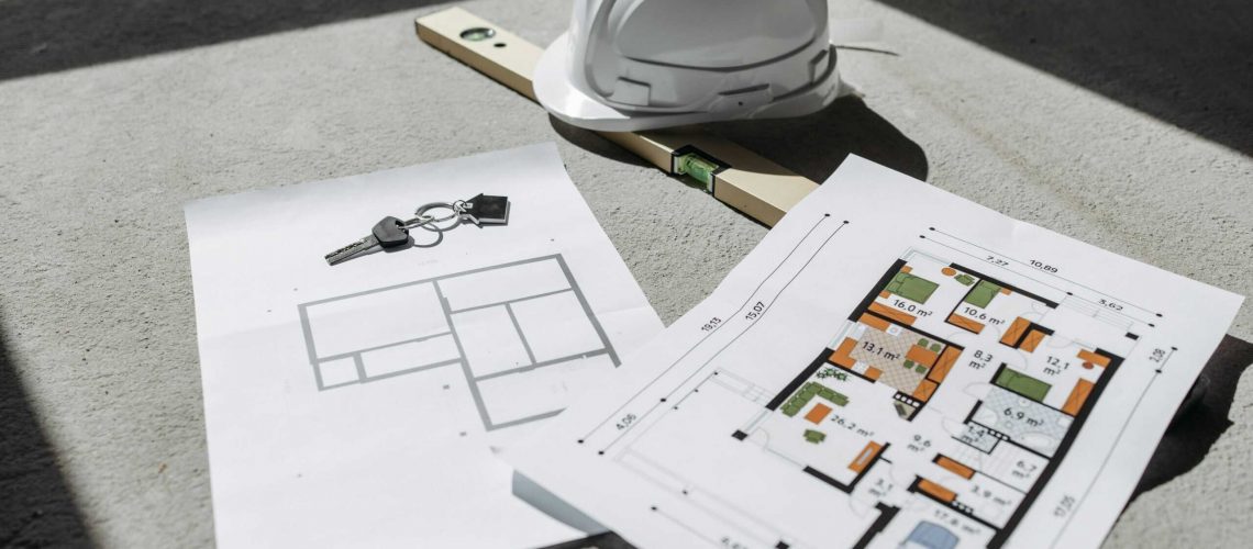 Helmet and architectural plans for construction and development projects.