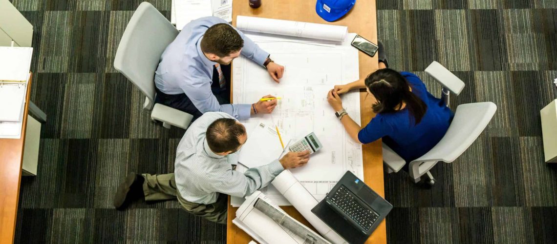 Business meeting discussing new HOA laws in Texas with homeowners and officials.