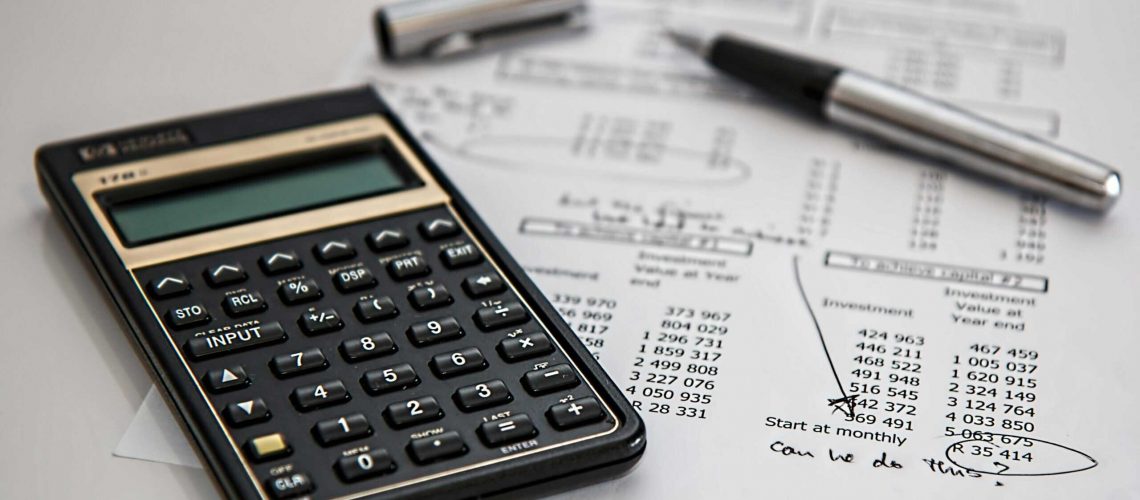 Calculator and financial documents for HOA budget planning and management.