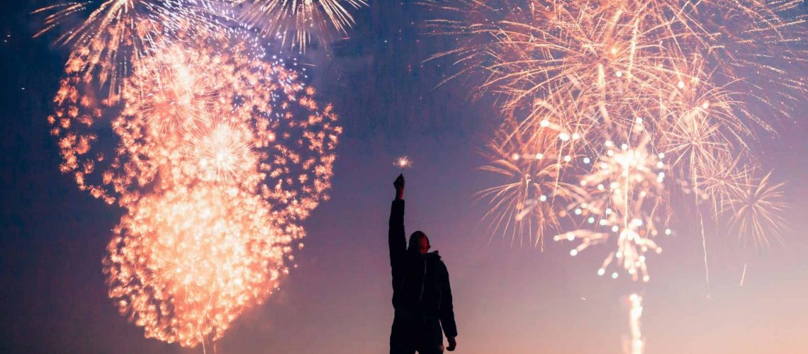 Fireworks display in Houston for July 4th celebrations with a person watching.