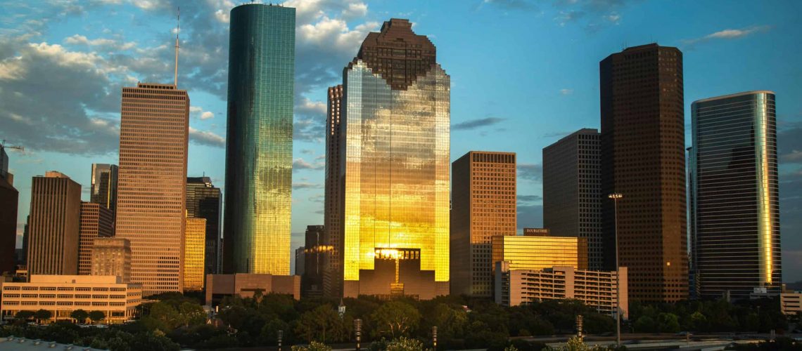 Houston skyline at sunset showcasing tall buildings and city lights for family fun.